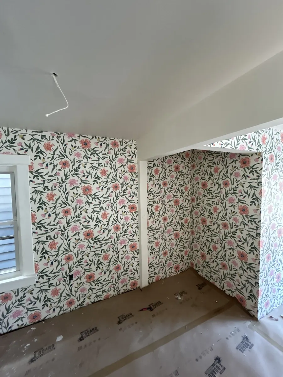 Coral and pink trailing vine floral wallpaper in a bedroom alcove — wallpaper installation by ProKir Design, serving Long Island & the Hamptons
