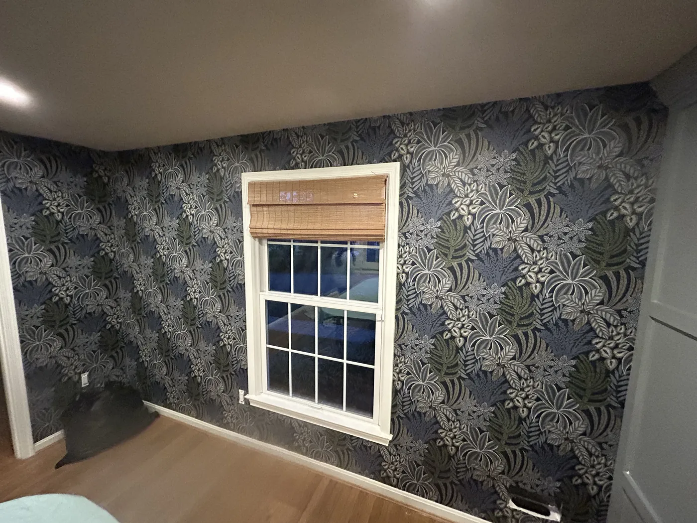 Indigo botanical wallpaper around a bedroom window — wallpaper installation by ProKir Design
