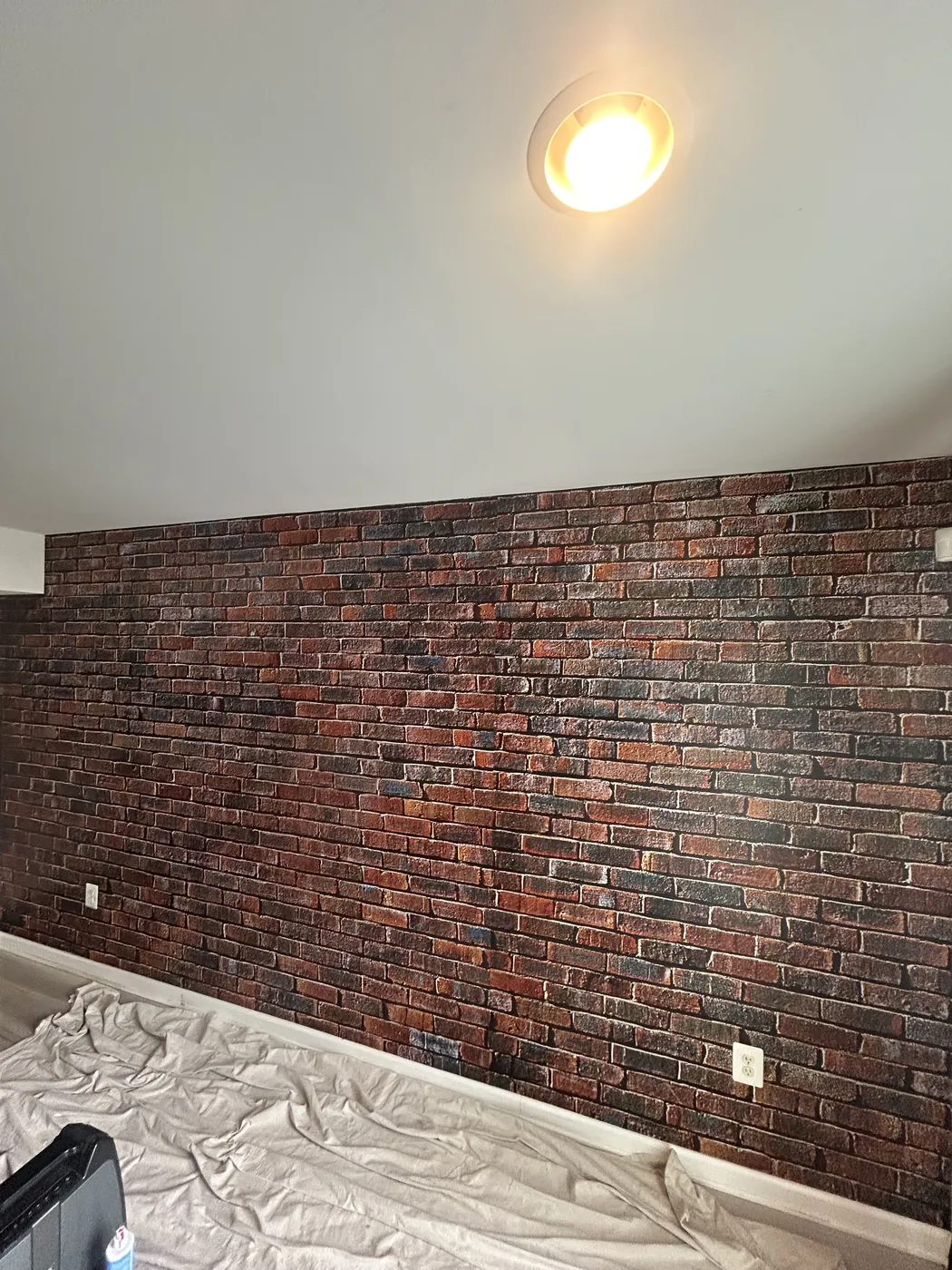 Red brick-effect wallpaper on an accent wall — wallpaper installation by ProKir Design