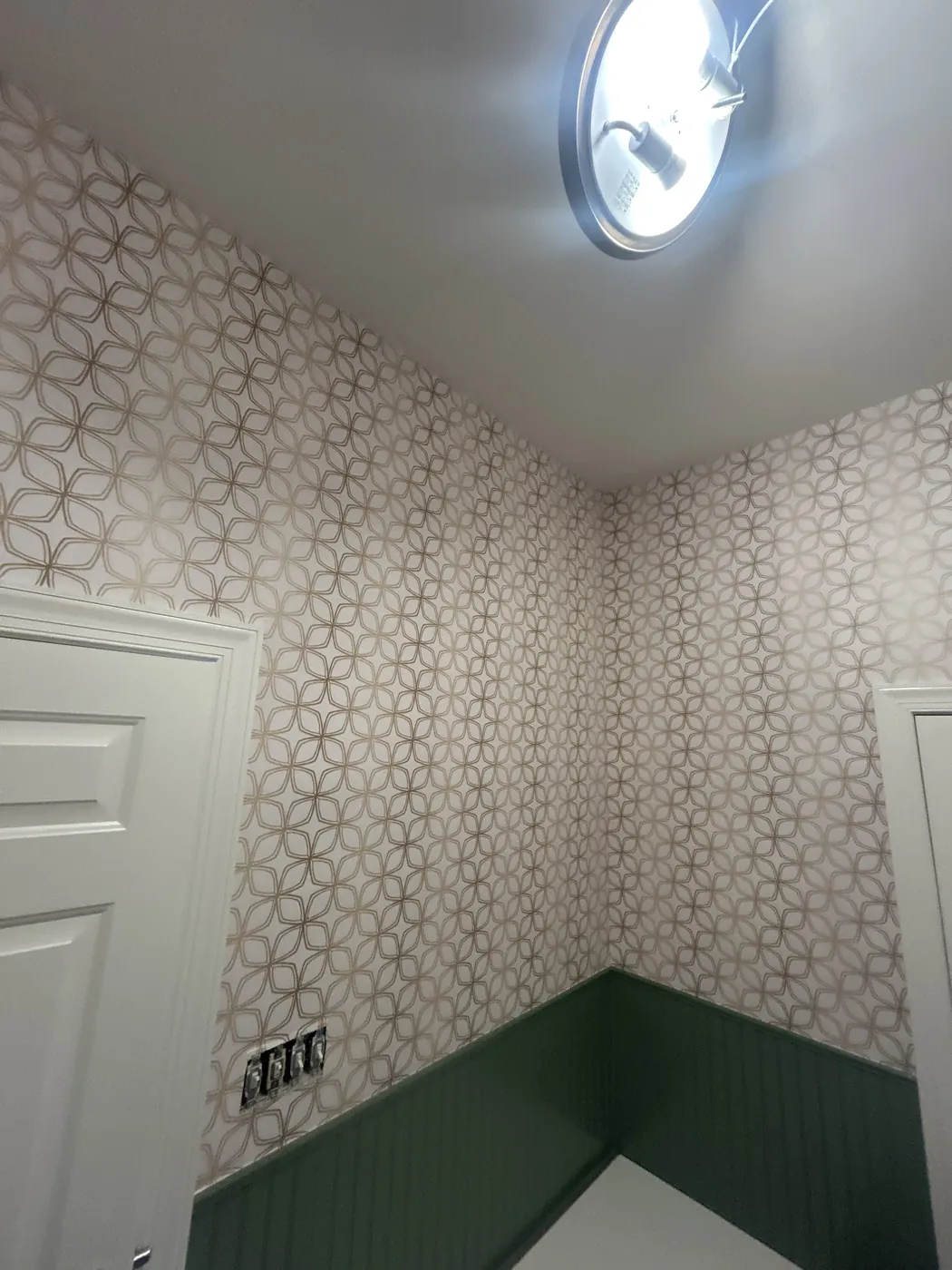 Light lattice wallpaper above green wainscoting — wallpaper installation by ProKir Design