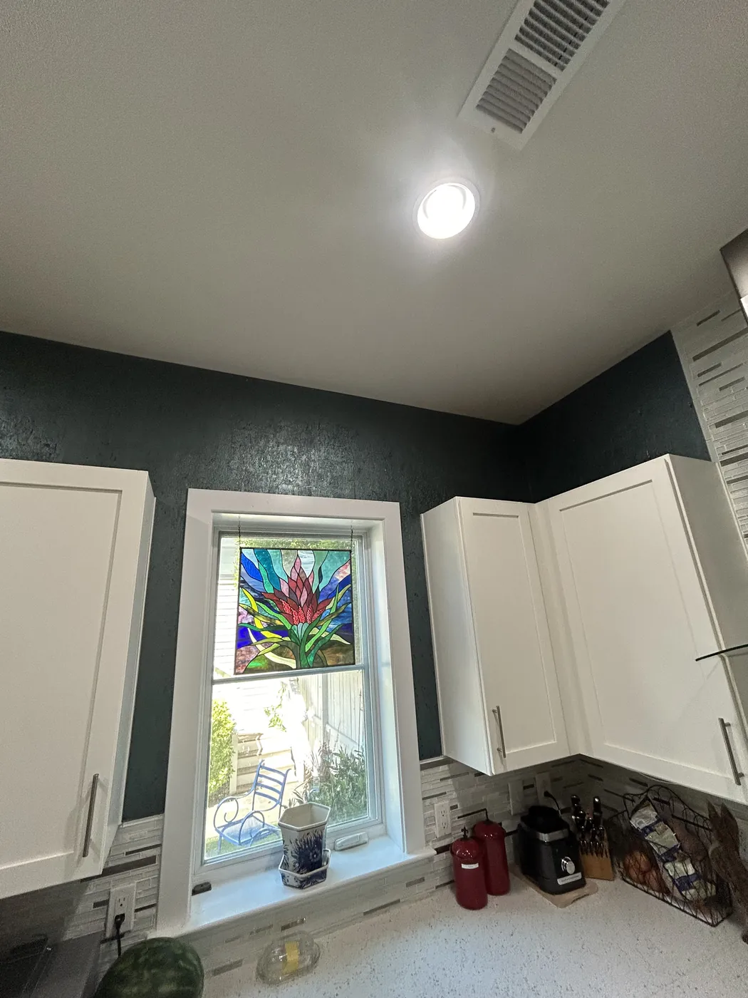 Dark textured wallcovering above white kitchen cabinets — wallpaper installation by ProKir Design