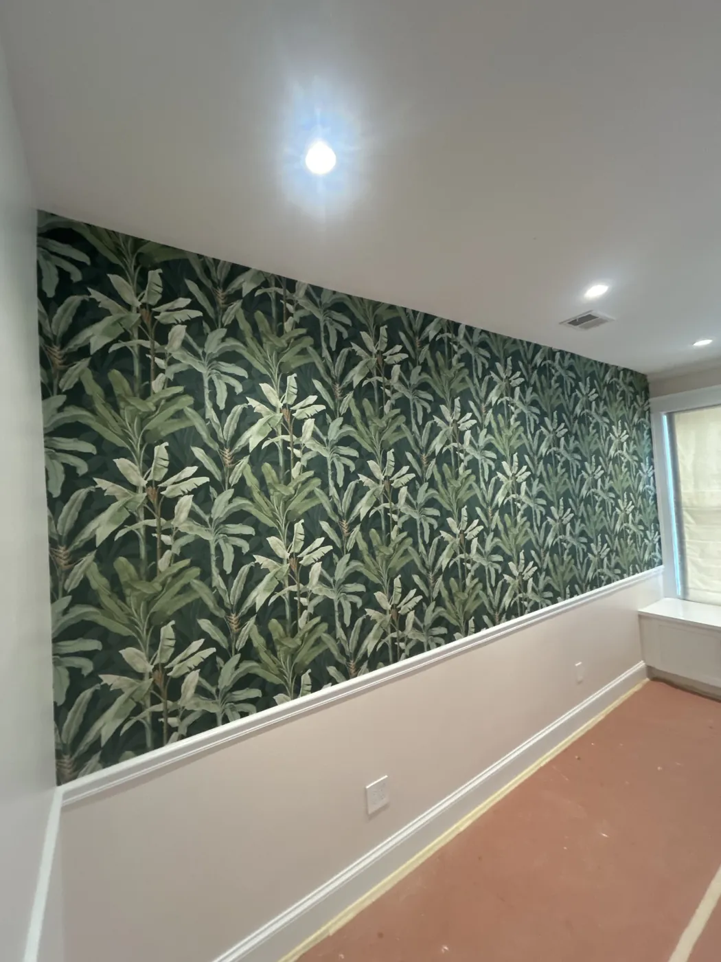 Green palm leaf wallpaper above a chair rail — wallpaper installation by ProKir Design