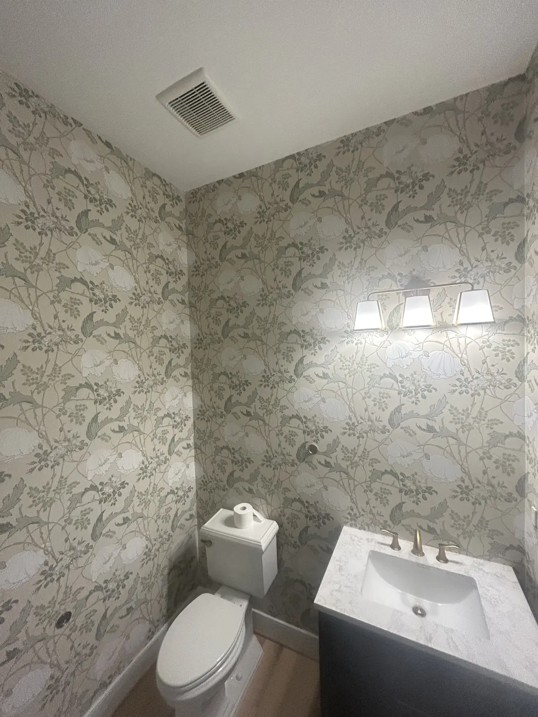 Sage floral wallpaper in a bathroom — wallpaper installation by ProKir Design