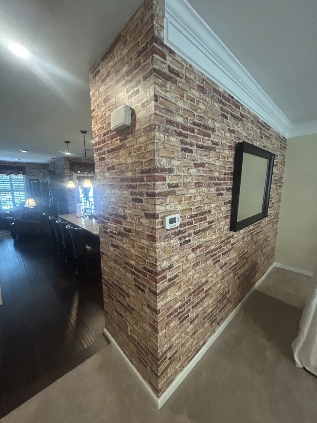 Brick-effect wallcovering on a living area wall — wallpaper installation by ProKir Design