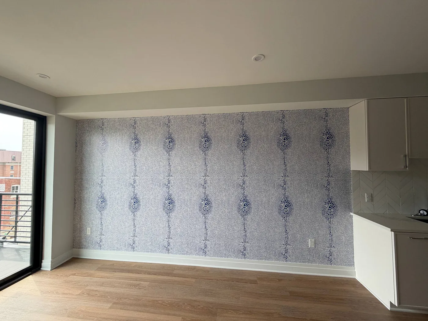 Blue ribbon stripe wallpaper on a living room accent wall — wallpaper installation by ProKir Design