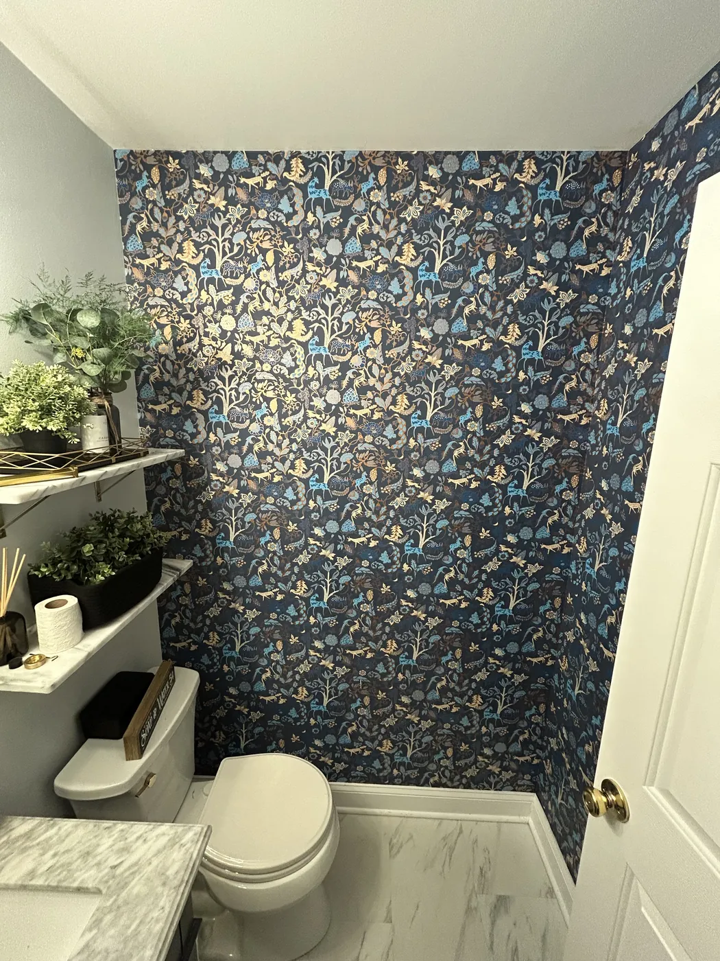 Navy botanical wallpaper in a bathroom — wallpaper installation by ProKir Design