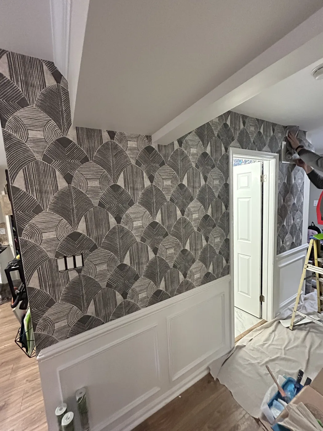 Graphic black and white leaf wallpaper above wainscoting — wallpaper installation by ProKir Design
