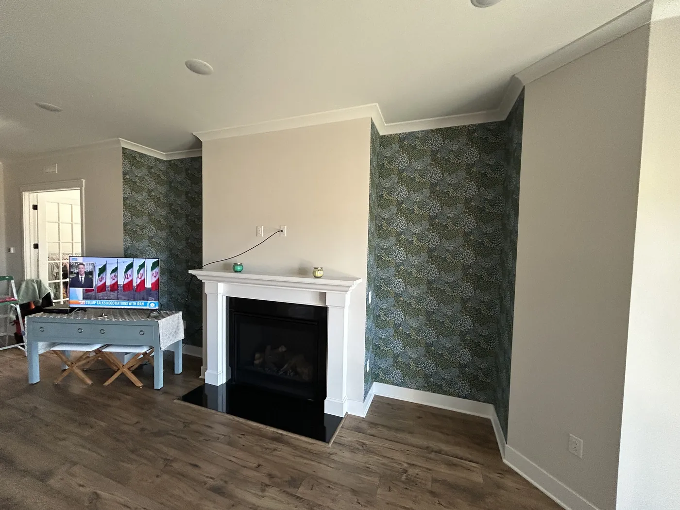 Wallpapered alcoves on both sides of a fireplace — wallpaper installation by ProKir Design