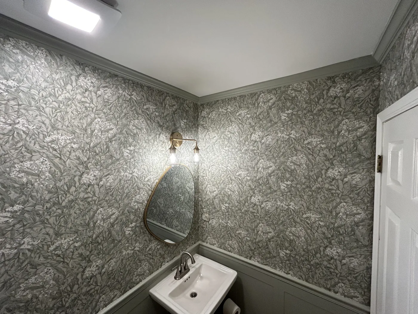 Grey leaf wallpaper in a powder room — wallpaper installation by ProKir Design