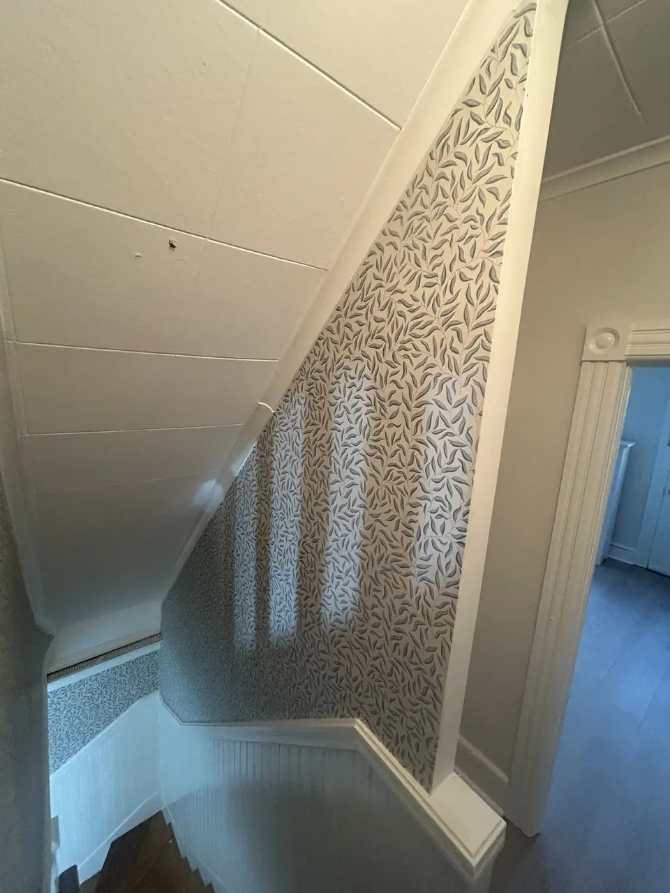 Leaf trail wallpaper along a stairwell — wallpaper installation by ProKir Design