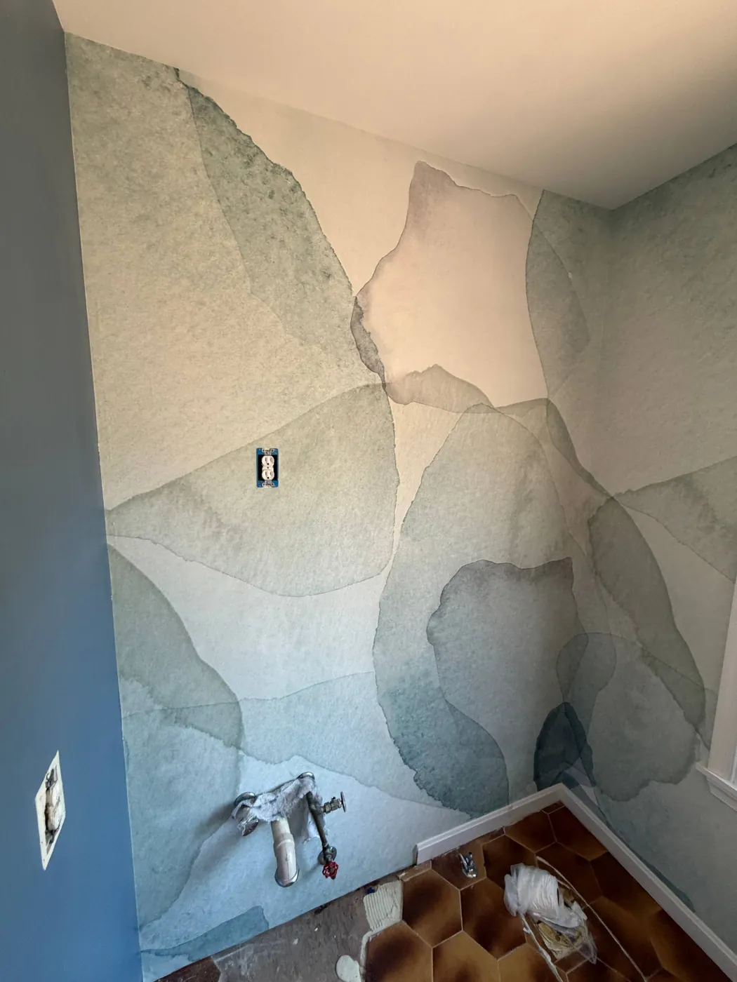 Soft watercolor mural on a bedroom wall — wallpaper installation by ProKir Design