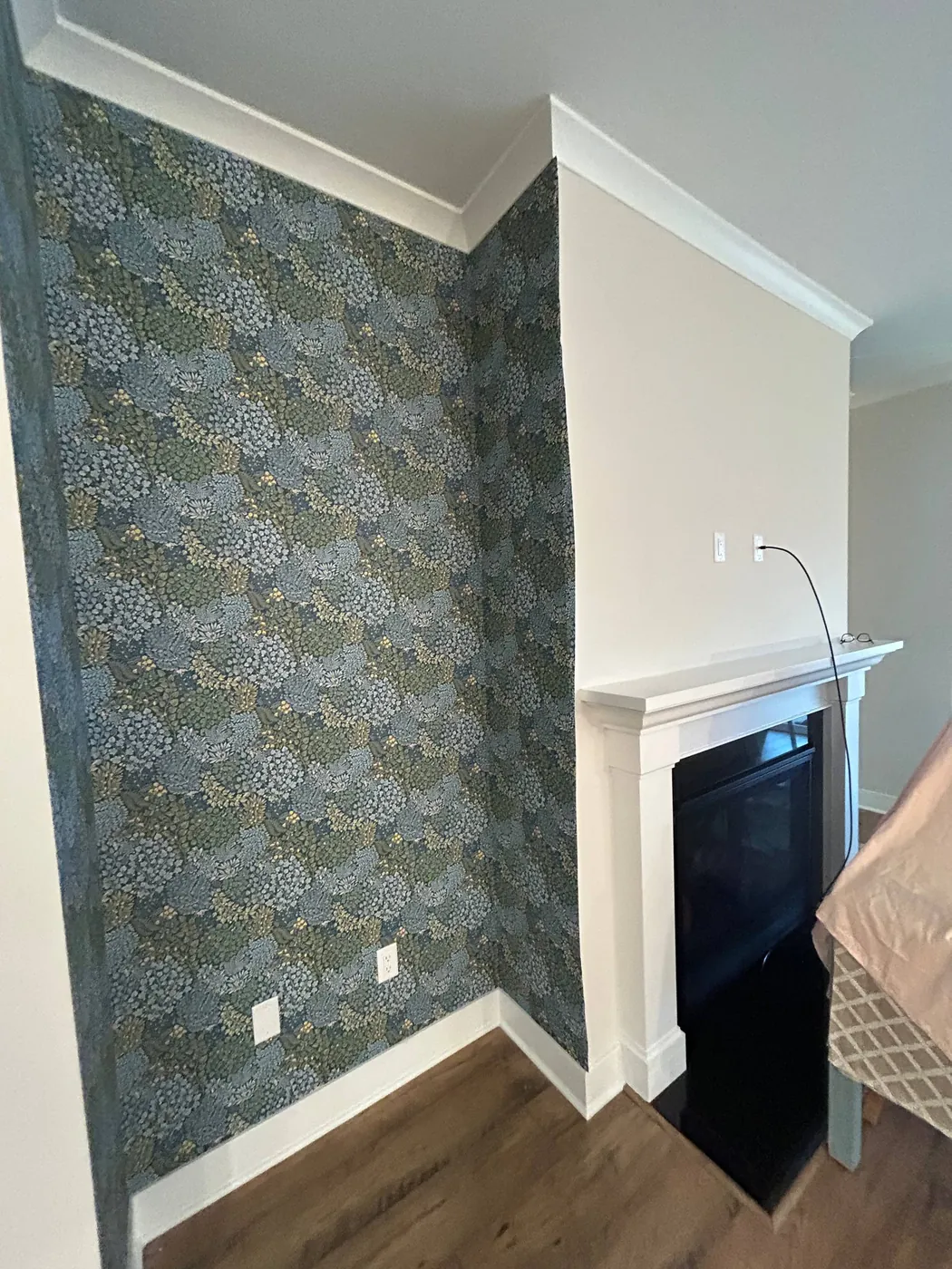 Botanical wallpaper beside a fireplace — wallpaper installation by ProKir Design