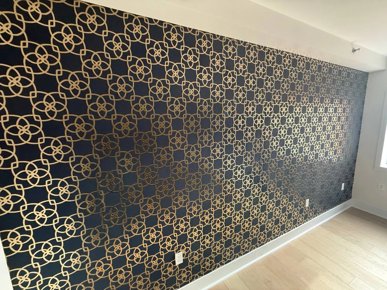 Navy and gold lattice wallpaper on an accent wall — wallpaper installation by ProKir Design