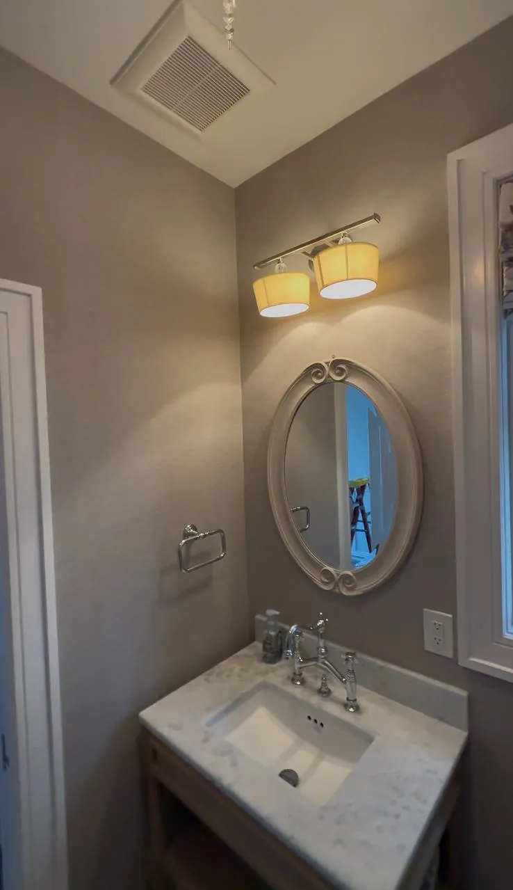 Neutral textured wallcovering in a powder room — wallpaper installation by ProKir Design