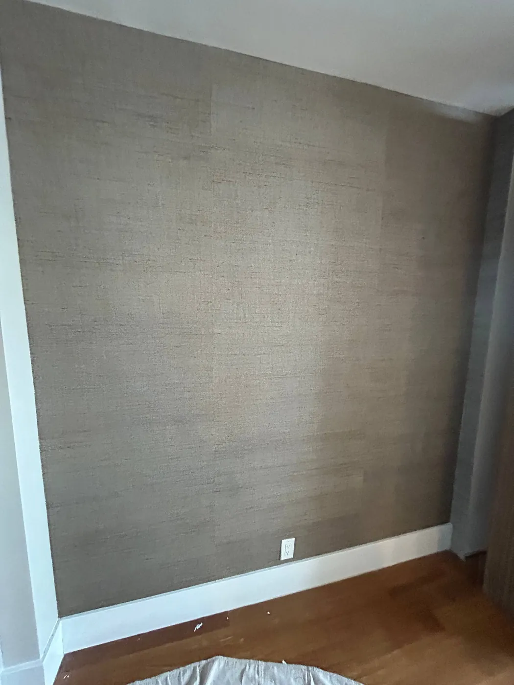 Grey grasscloth on a bedroom wall — wallpaper installation by ProKir Design