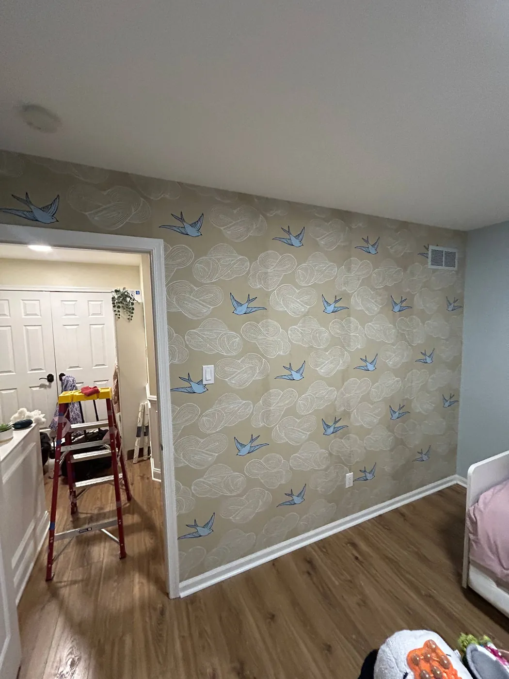 Blue birds-in-flight wallpaper on a bedroom wall — wallpaper installation by ProKir Design