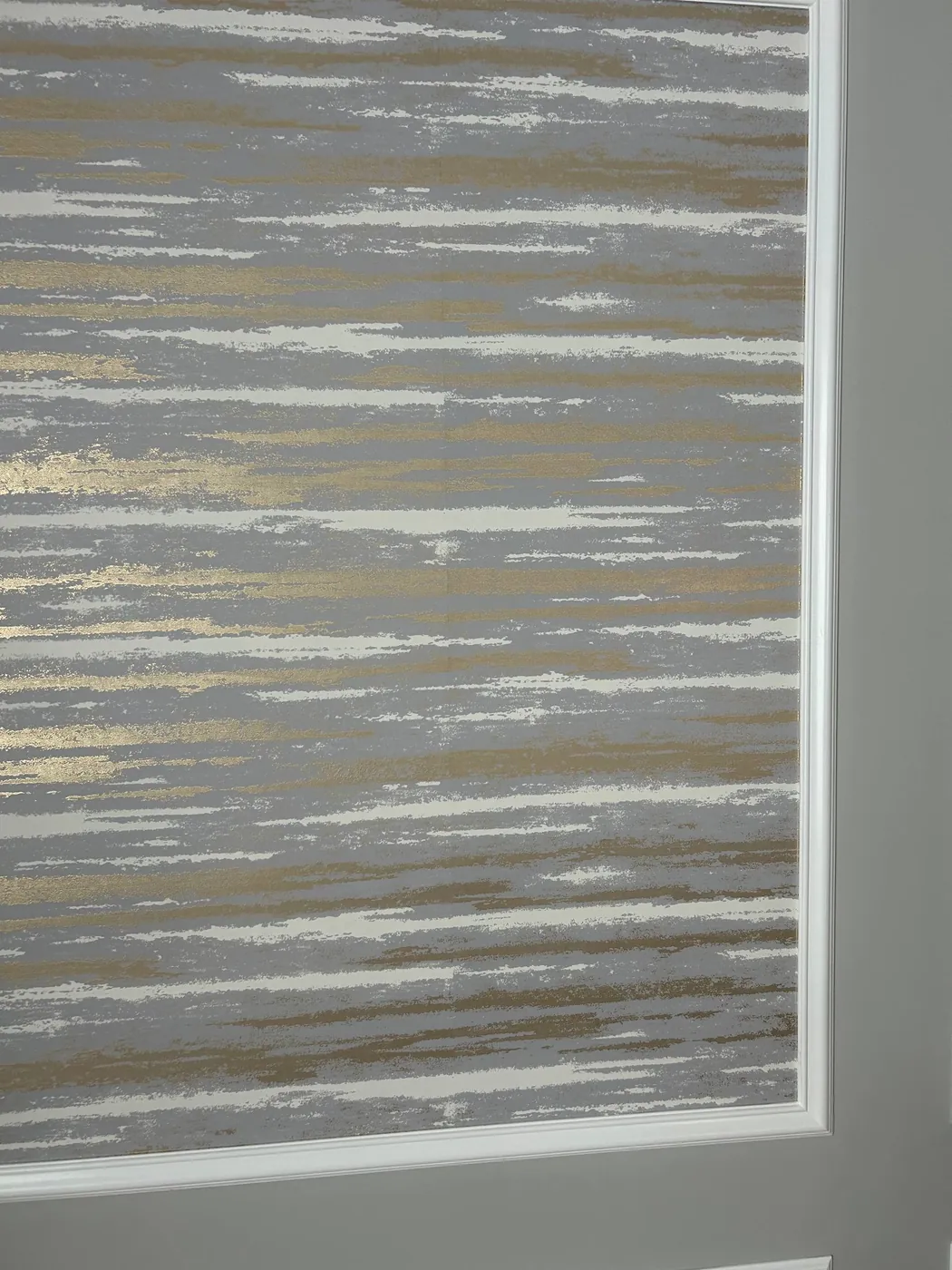 Metallic strié wallpaper set inside a molding frame — wallpaper installation by ProKir Design