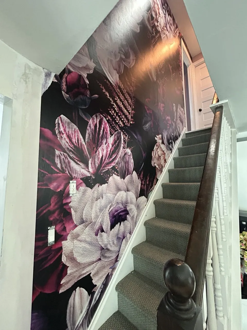 Oversized dark floral mural along a staircase — wallpaper installation by ProKir Design