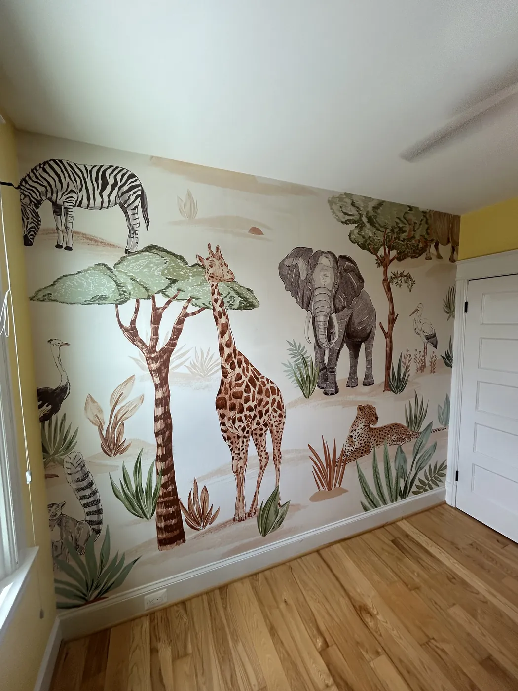 Safari animal mural in a nursery — wallpaper installation by ProKir Design