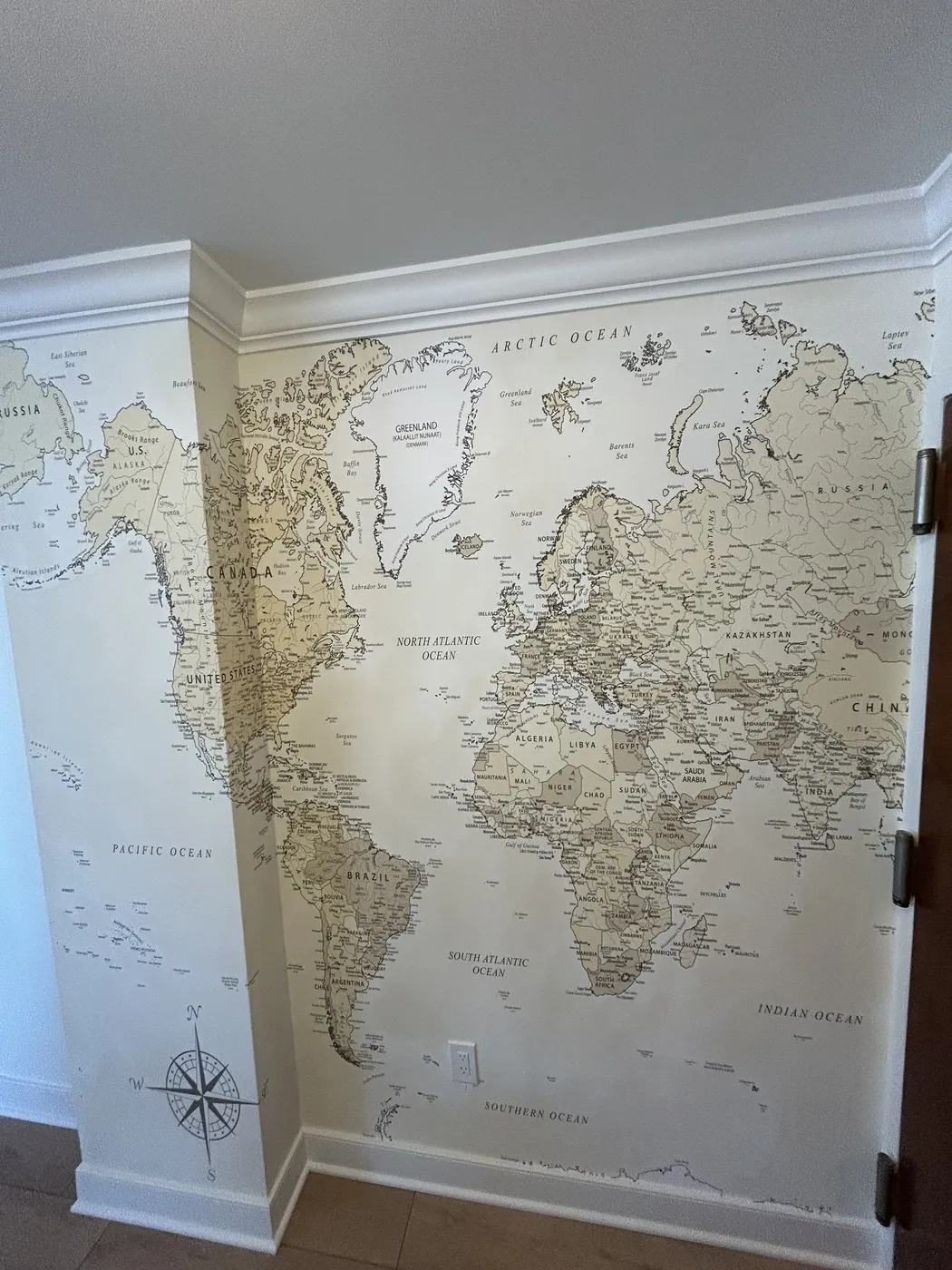 Vintage world map mural between hallway pilasters — wallpaper installation by ProKir Design