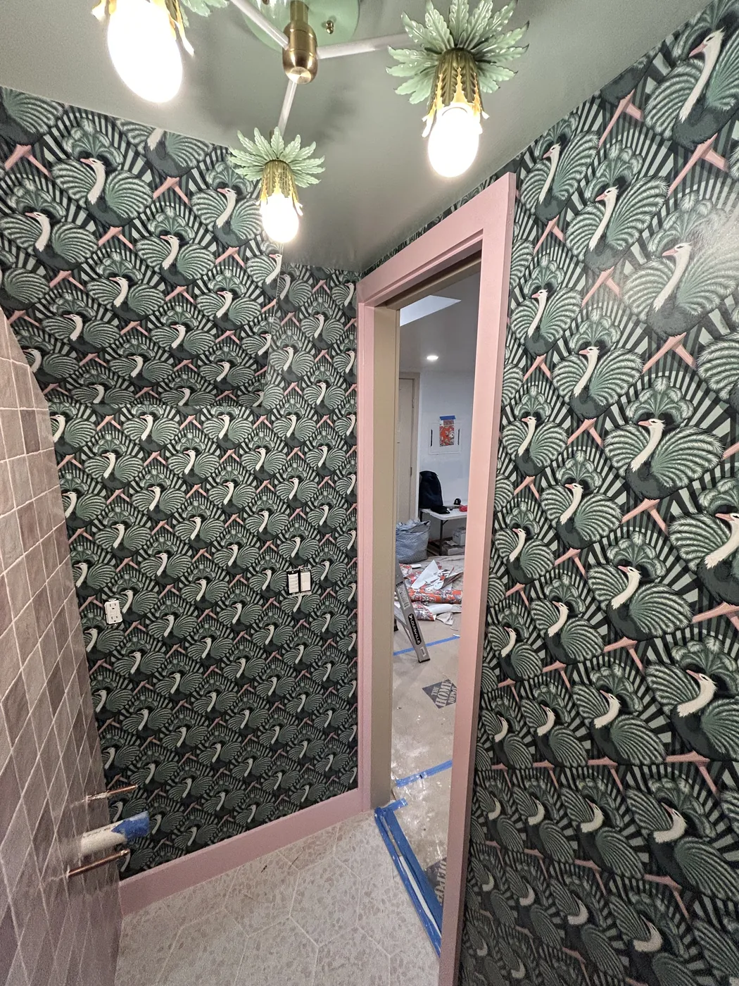 Swan pattern wallpaper above pink tile in a bathroom, Westchester County — wallpaper installation by ProKir Design