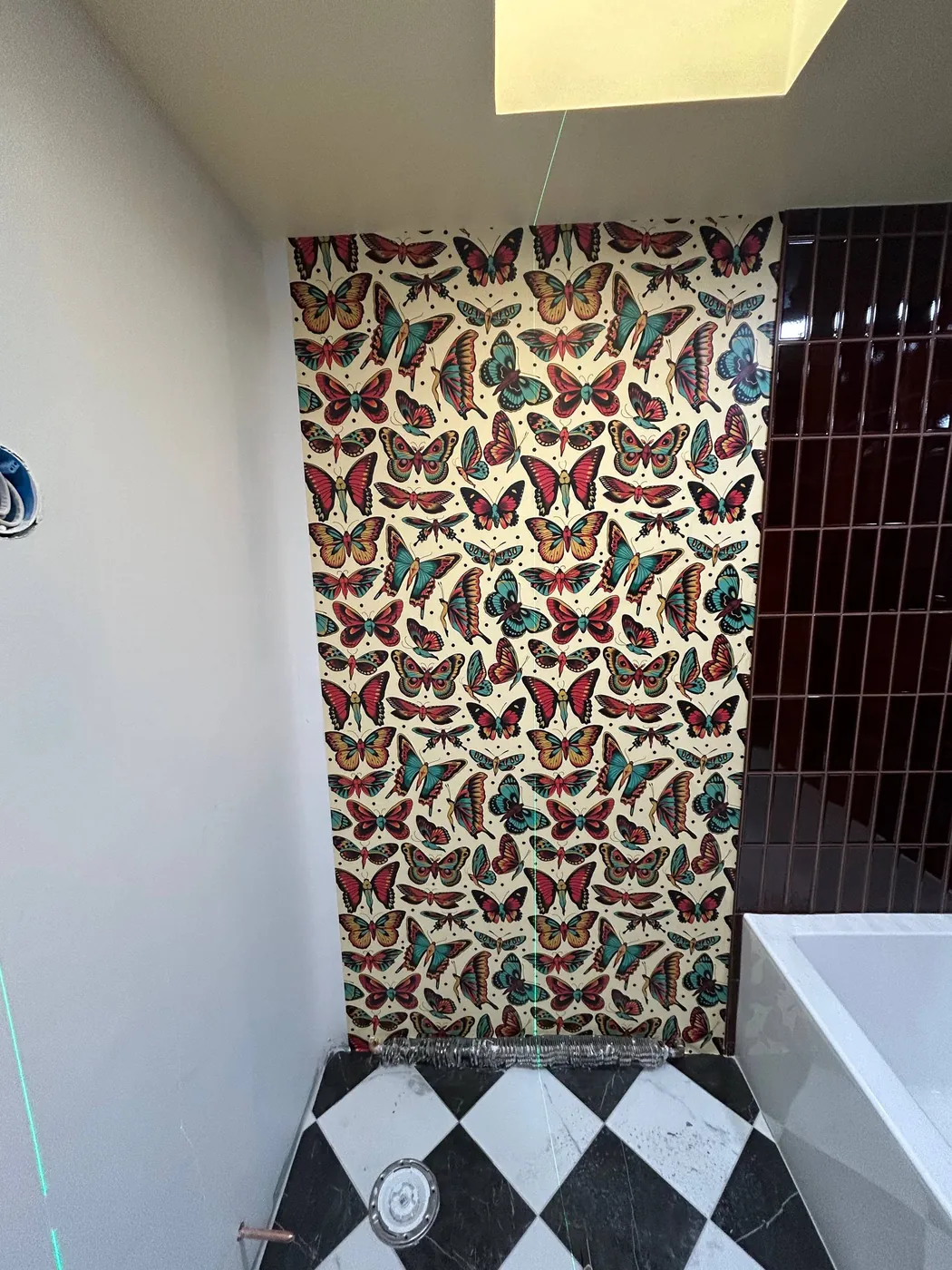 Butterfly print wallpaper on a bathroom wall — wallpaper installation by ProKir Design