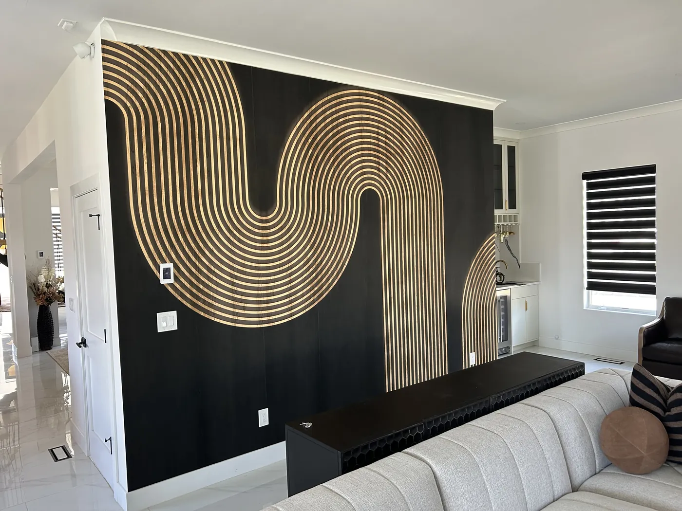 Gold wave line mural on a black feature wall, Westchester County — wallpaper installation by ProKir Design