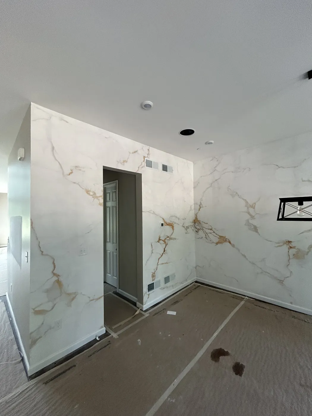Floors protected before a marble-effect wallpaper installation — wallpaper installation by ProKir Design