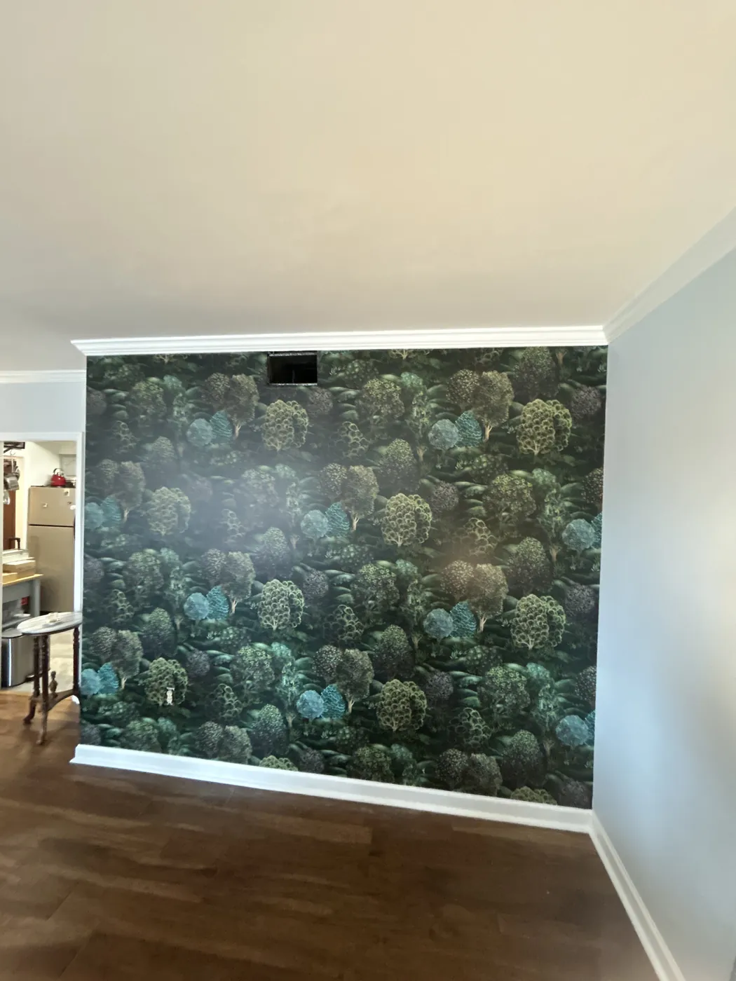 Dark green forest canopy wallpaper on an accent wall — wallpaper installation by ProKir Design