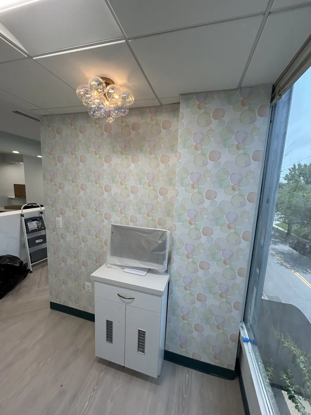 Pastel pattern wallcovering in a dental treatment room — wallpaper installation by ProKir Design