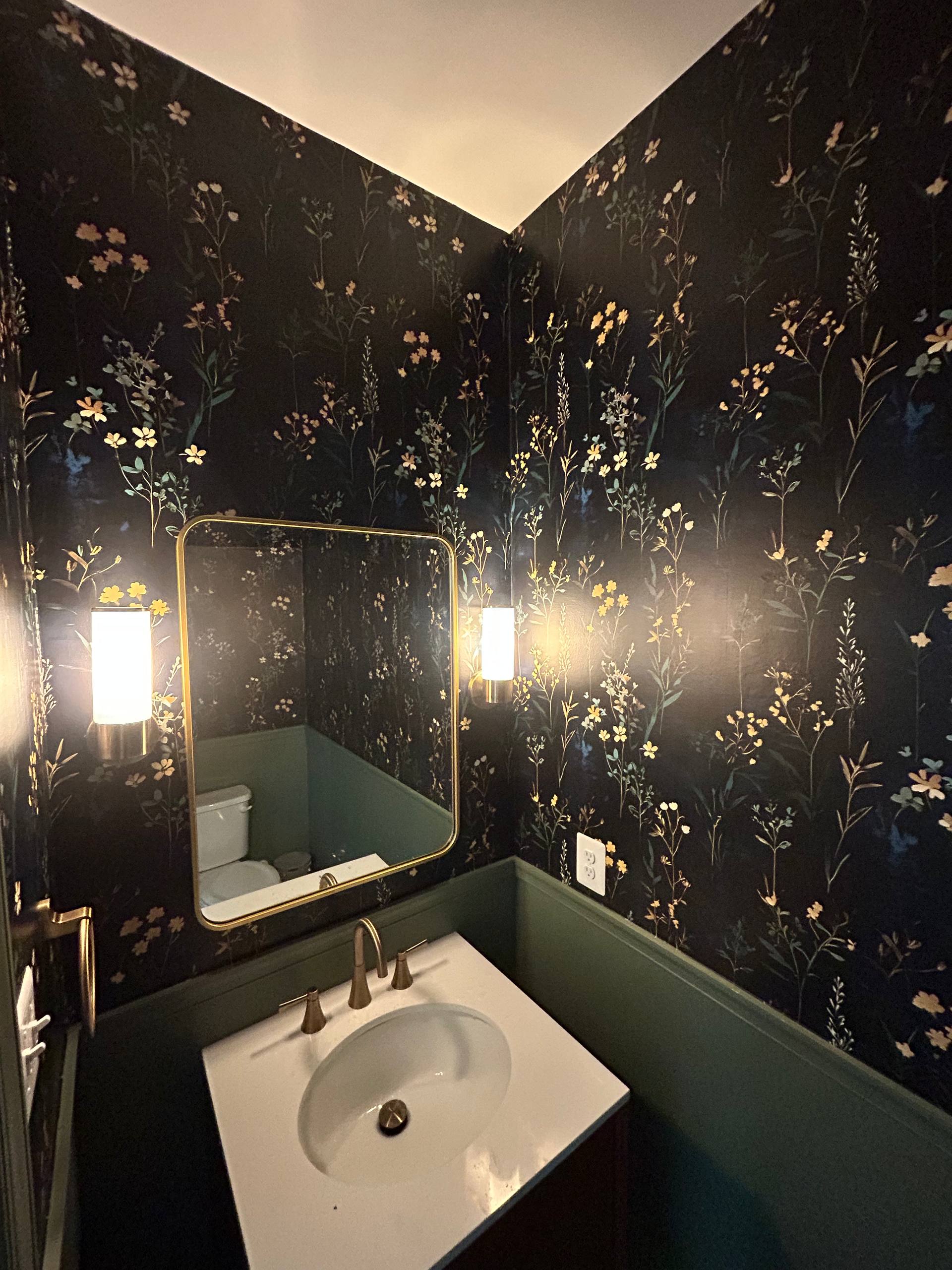 Elegant dark floral wallpaper in bathroom with gold-framed mirror