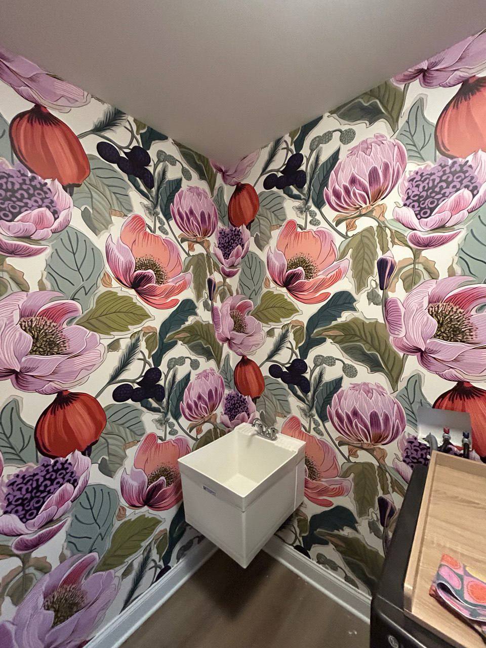 Vibrant pink floral wallpaper in laundry room