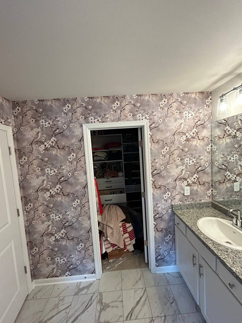 Delicate cherry blossom wallpaper installation in bathroom