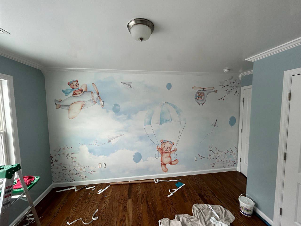 Custom nursery mural with flying bears and parachutes
