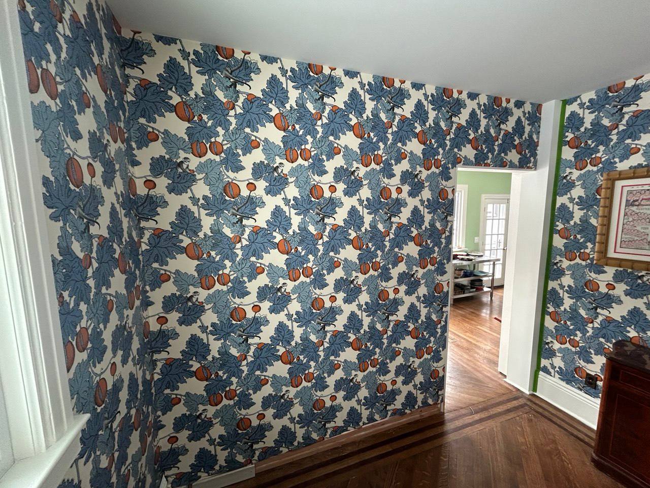Bold blue and orange botanical wallpaper in living area